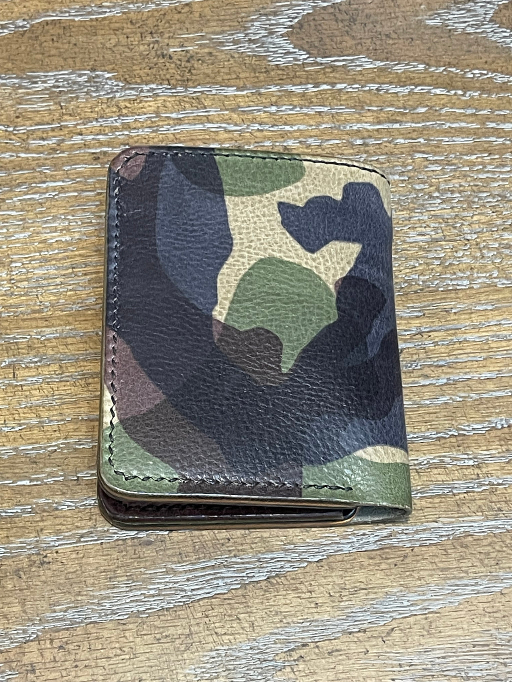 8 pocket bifold wallet with camouflage outer shell and solid Pueblo inner pockets.