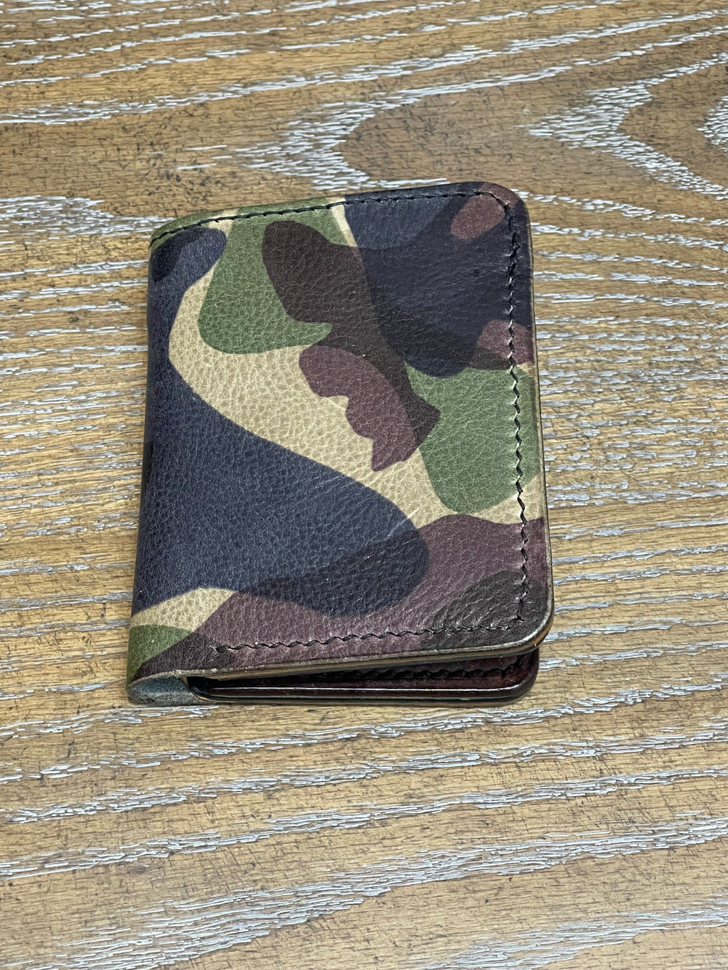 8 pocket bifold wallet with camouflage outer shell and solid Pueblo inner pockets.